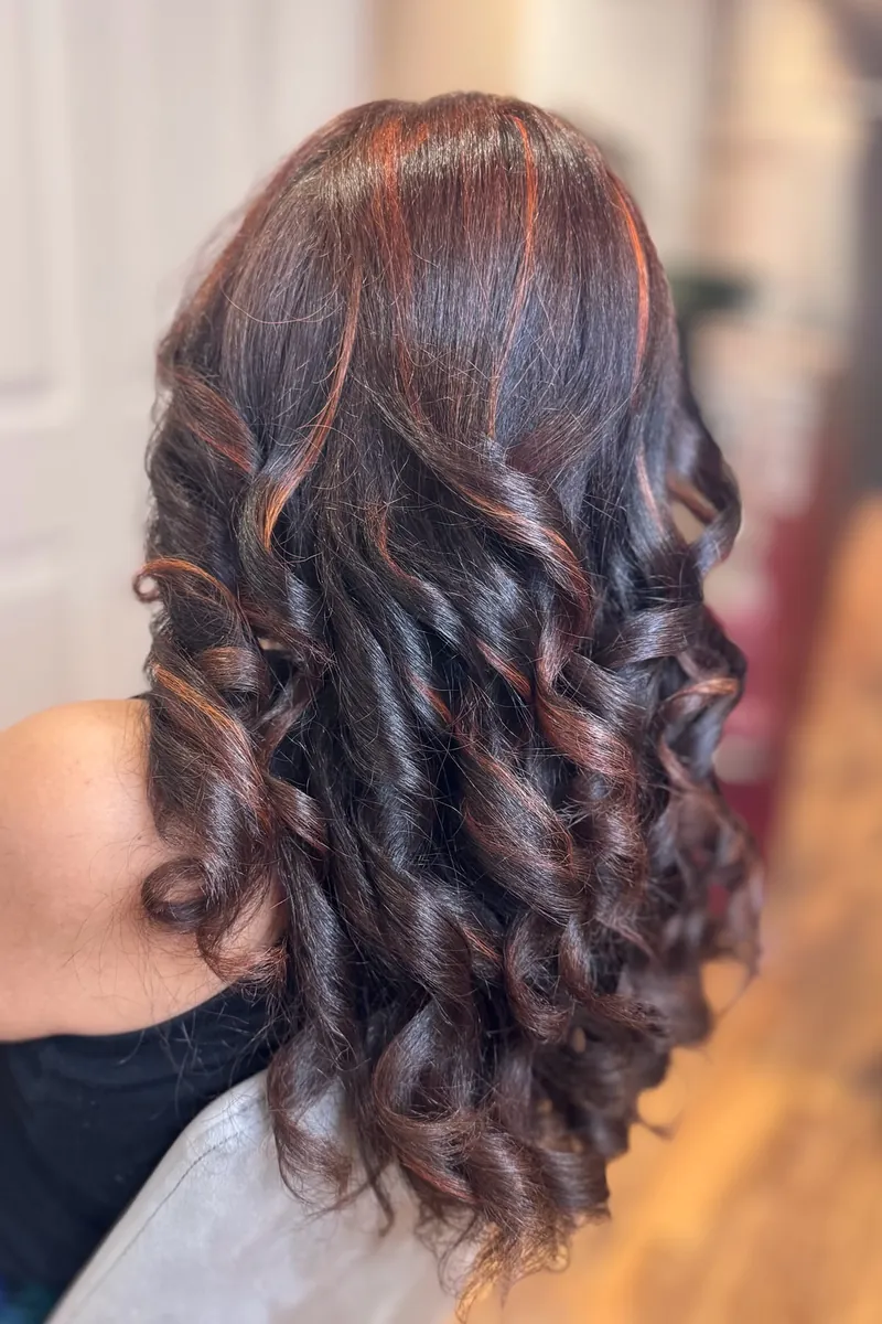 Rich copper curls with deep onyx dimension