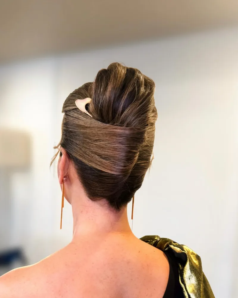Blonde half-up style with loose waves on a black background