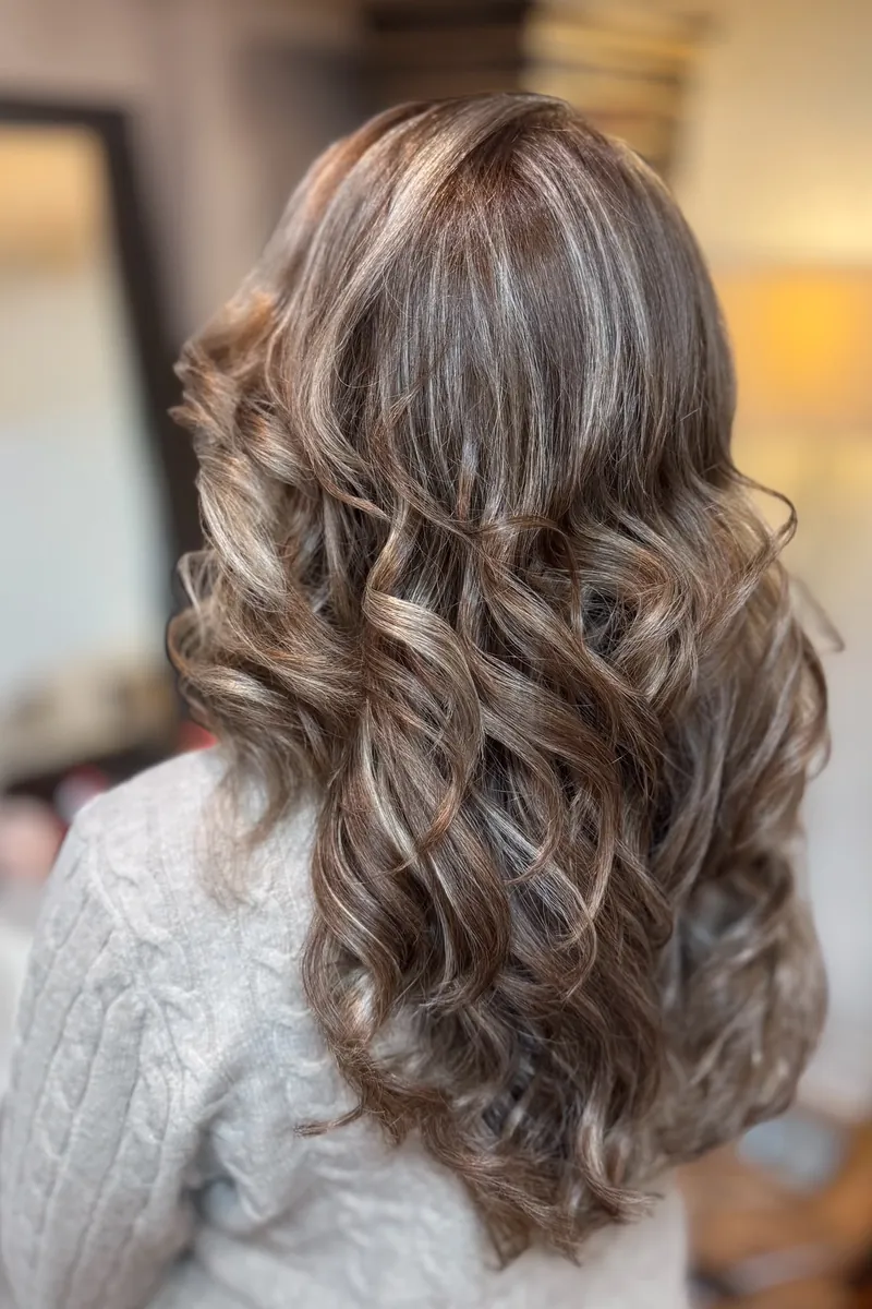 Warm brunette waves with golden highlighted dimension