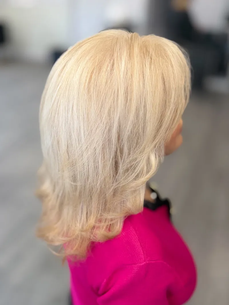 Side profile of long platinum blonde layers with soft movement